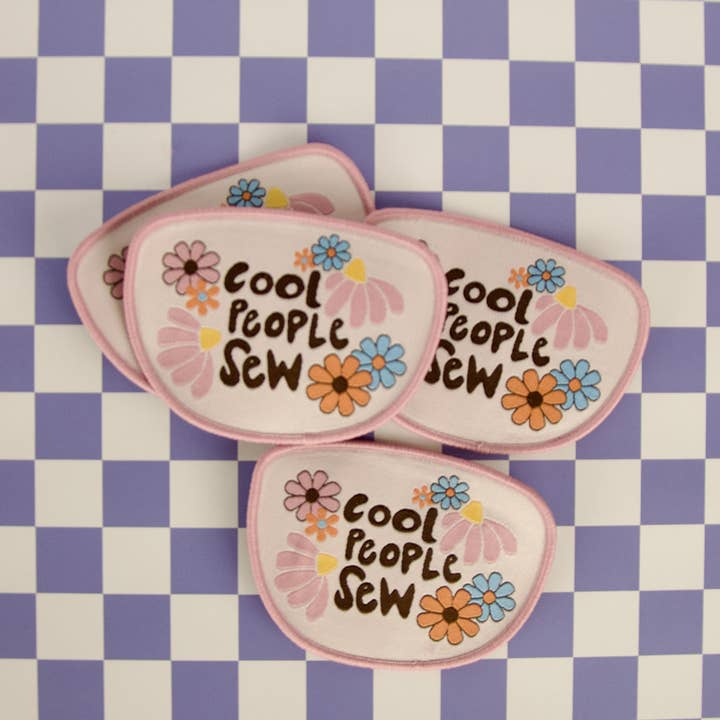 Three 'Cool People Sew' patches with floral designs on a checkered background
