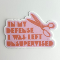 Sticker with scissors and text 'In my defense I was left unsupervised' on a light gray background