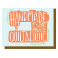 Decorative sign with sewing machine graphic and text 'Handmade by your favorite Quiltaholic' on a light blue background.
