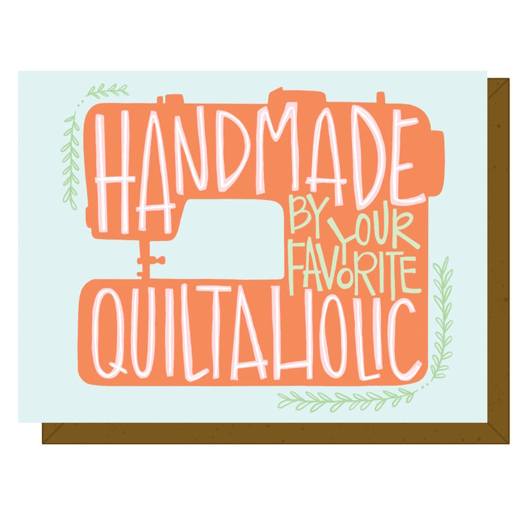 Decorative sign with sewing machine graphic and text 'Handmade by your favorite Quiltaholic' on a light blue background.