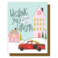 Christmas card with a red truck, houses, and trees on a light blue background.