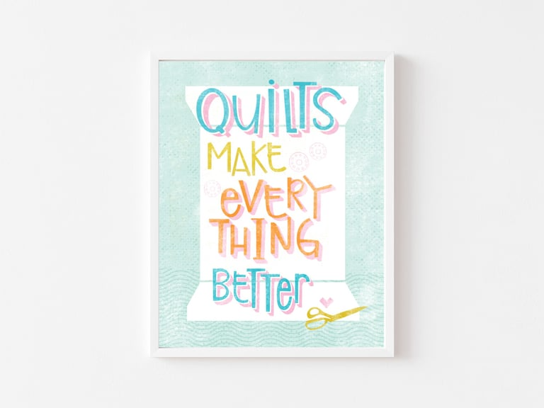 Poster with colorful text 'Quilts make everything better' on a light blue background