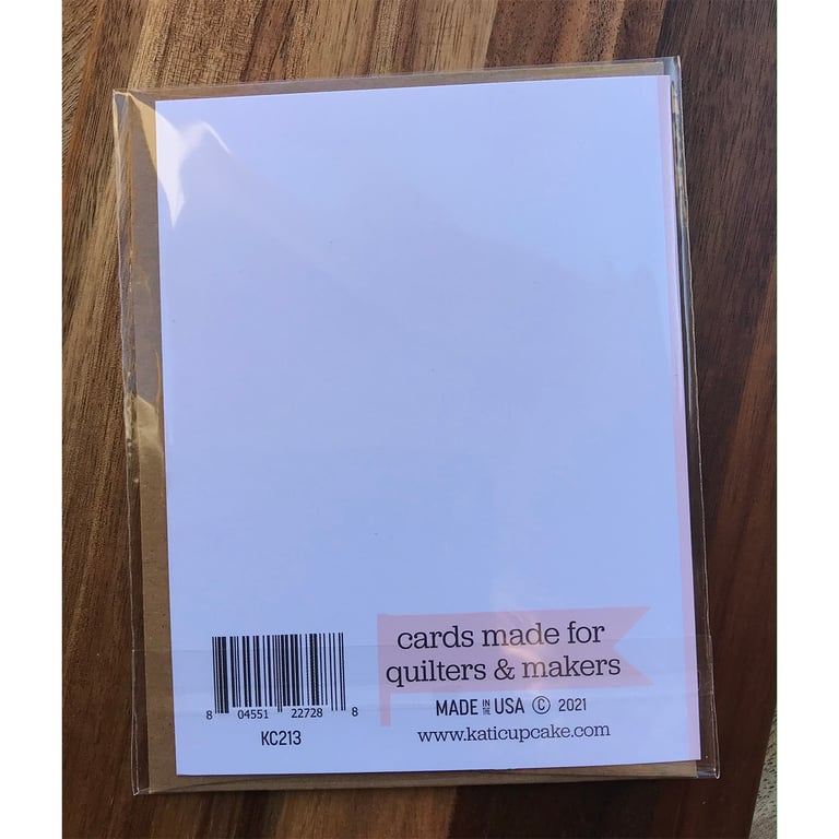 Packaged card set with 'cards made for quilters & makers' label on a wooden surface
