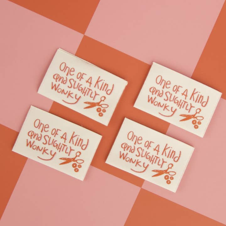 Four identical cards with text and a design on a checkered background