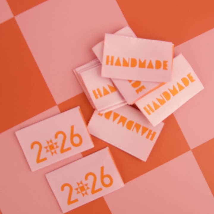 Pink labels with 'HANDMADE' and numbers on a pink and orange checkered background