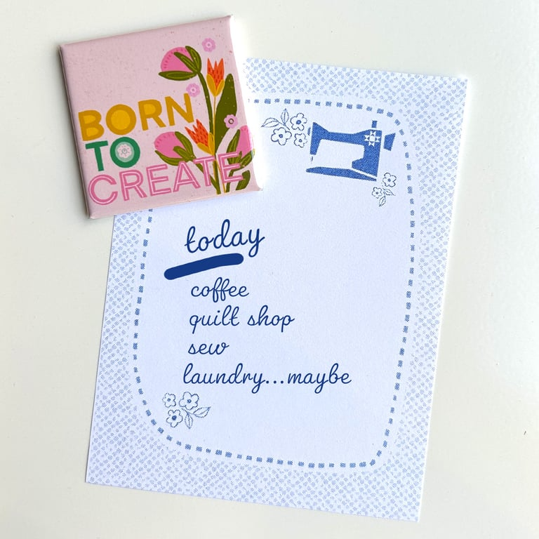 Notebook with 'Born to Create' cover and a motivational quote on a light background