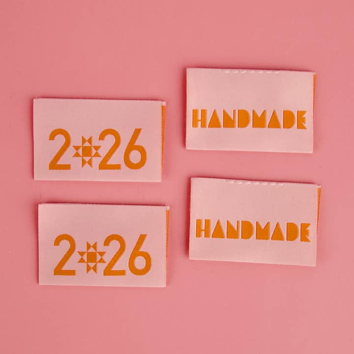 Four pink labels with '226' and 'HANDMADE' text on a pink background