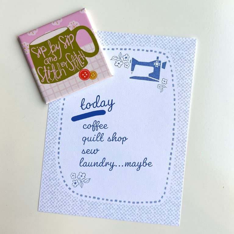 Notebook with sewing-themed cover and text on a light background